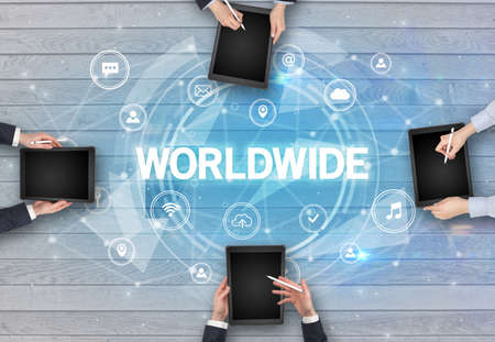 Group of people having a meeting with WORLDWIDE insciption, social networking conceptの写真素材