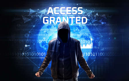 Faceless hacker at work with ACCESS GRANTED inscription, Computer security conceptの写真素材