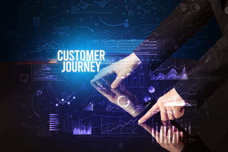Businessman touching huge screen with CUSTOMER JOURNEY inscription, cyber business conceptの写真素材