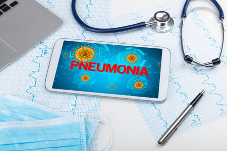 Close-up view of a tablet pc with PNEUMONIA inscription, microbiology conceptの写真素材