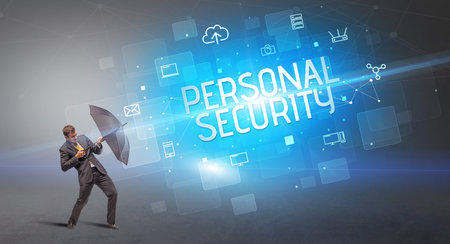 Businessman defending with umbrella from cyber attack and PERSONAL SECURITY inscription, online security conceptの写真素材