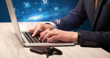 Businessman working on laptop with PREPAY inscription, online shopping concept