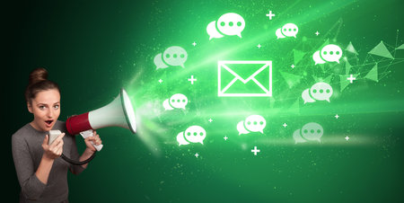 Young person yelling in loudspeaker with envelope icon, modern technology conceptの写真素材