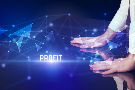 Businessman touching huge screen with PROFIT inscription, modern technology business conceptの写真素材