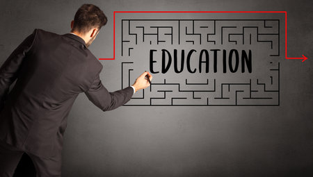 businessman drawing maze with EDUCATION inscription, business education conceptの写真素材