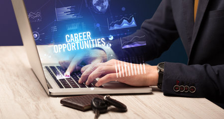Businessman working on laptop with CAREER OPPORTUNITIES inscription, new business conceptの写真素材