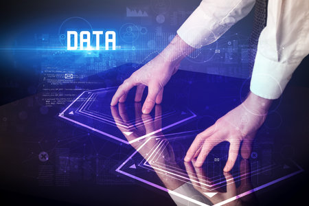 Hand touching digital table with DATA inscription, new age security conceptの写真素材