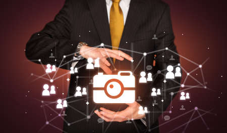 Hand holdig camera icon around his hands, Social networking conceptの写真素材