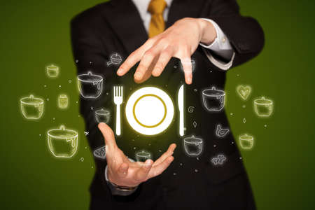 Hand holding tableware icon, healthy food delivery conceptの写真素材