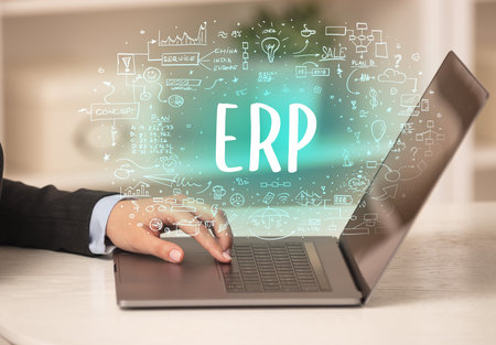 hand working on new modern computer with ERP abbreviation, modern technology conceptの写真素材