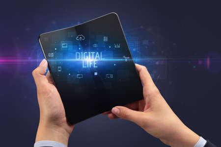 Businessman holding a foldable smartphone, security conceptの写真素材