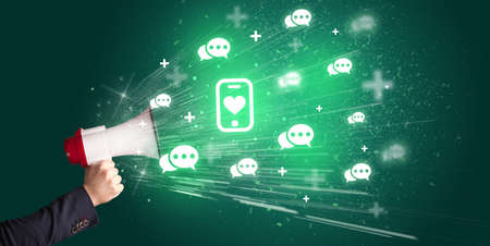 Young person with megaphone and social networking iconの写真素材