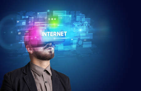 Businessman looking through Virtual Reality glassesの写真素材