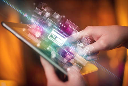 Close-up of a hand using tablet, currency concept