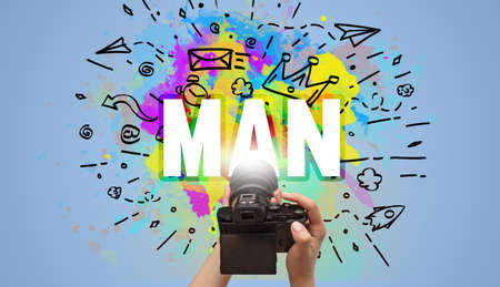 Close-up of a hand holding digital camera with abstract drawingの写真素材