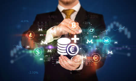 Businessman holding currency symbols conceptの写真素材