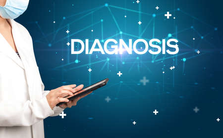 Doctor fills out medical recordの写真素材
