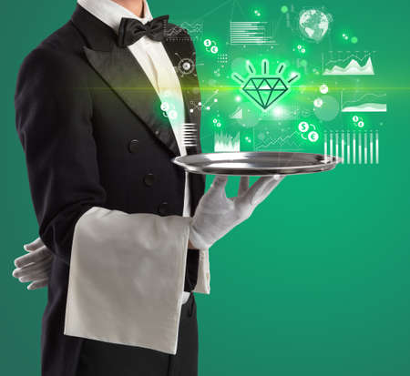 Handsome young waiter in tuxedo holding currency icons on tray