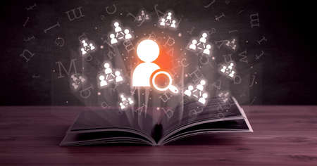 Open book with social networking icons aboveの写真素材