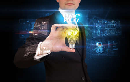 Businessman holding a light bulb, online security conceptの写真素材