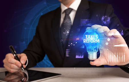 Businessman holding a light bulb, new business conceptの写真素材