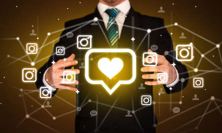 Hand holding social media icons