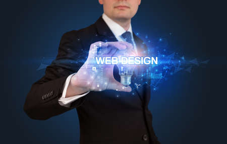 Businessman holding a light bulbの写真素材