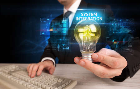 Businessman holding a light bulb, online security conceptの写真素材