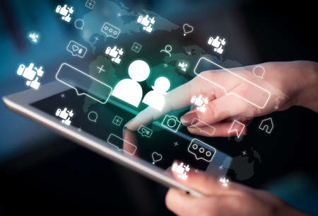 Close-up of a hand using tablet, social media concept