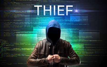 Faceless hacker on code backgroundの写真素材