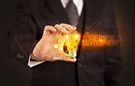 Businessman holding a lightbulb conceptの写真素材