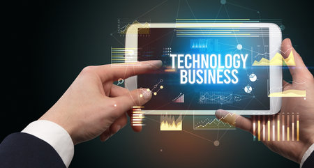 Close-up of hands holding tablet with business inscriptionの写真素材