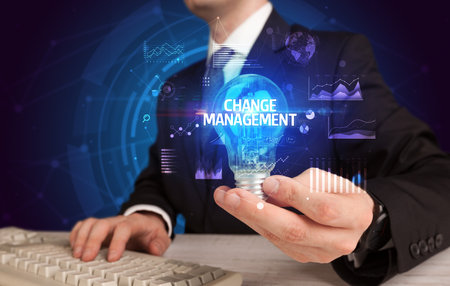 Businessman holding a light bulb, new business conceptの写真素材