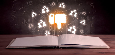 Open book with social networking icons aboveの写真素材