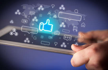 Close-up of a hand using tablet, social media concept