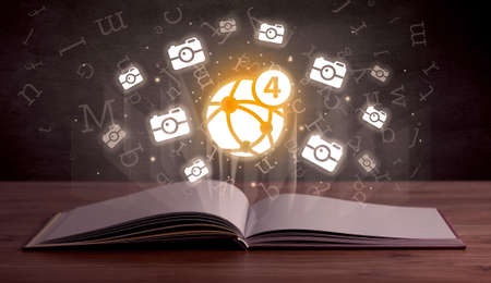 Open book with social networking icons aboveの写真素材