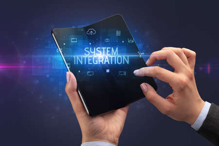 Businessman holding a foldable smartphone, security conceptの写真素材