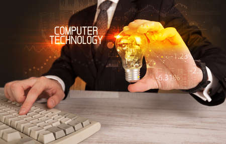 Businessman holding a lightbulb conceptの写真素材