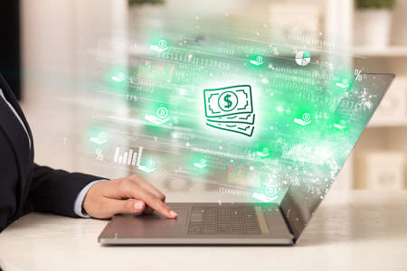 Young man watching stock market on laptopの写真素材