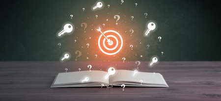 Open book with business icons aboveの写真素材