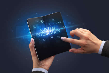 Businessman holding a foldable smartphone, security conceptの写真素材