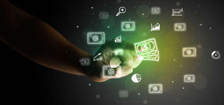 Businessman finger touching on screen multimedia interface with hand drawn currency iconsの写真素材