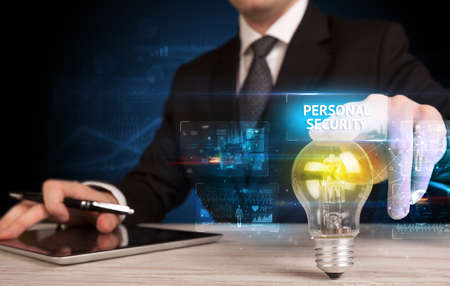Businessman holding a light bulb, online security conceptの写真素材