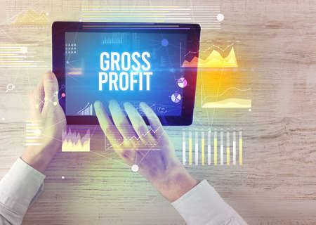 Close-up of hands holding tablet with business inscriptionの写真素材