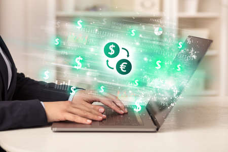 Young man watching stock market on laptopの写真素材