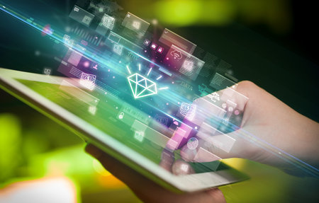 Close-up of a hand using tablet, currency conceptの写真素材