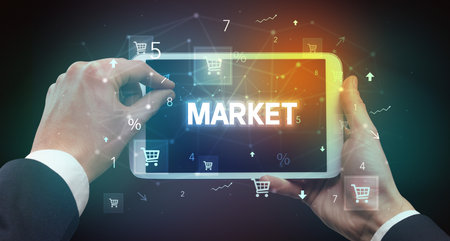 Close-up of a hand holding tablet with shopping inscriptionの写真素材