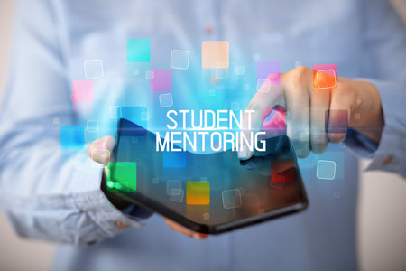 Young man holding a foldable smartphoneの写真素材