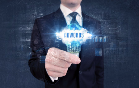 Businessman holding a light bulb, business conceptの写真素材