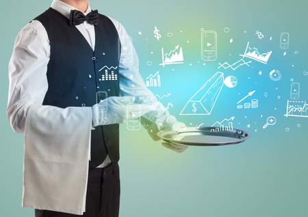Handsome young waiter in tuxedo holding money icons on trayの写真素材
